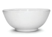 A white ceramic bowl with a subtle horizontal ribbed texture around the exterior. The bowl has a ramekin-inspired, rounded shape, a slightly flared rim, and sits on a small circular base. The background is plain white.