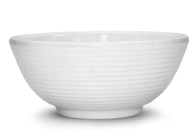 A white ceramic bowl with a subtle horizontal ribbed texture around the exterior. The bowl has a ramekin-inspired, rounded shape, a slightly flared rim, and sits on a small circular base. The background is plain white.