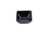 A small, empty, square-shaped black melamine bowl with slightly flared sides sits against a white background. The bowl appears to have a smooth, glossy interior and a matte, textured exterior, and is dishwasher safe.