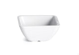 A small, empty, white ceramic ramekin with a square shape and gently rounded edges. The bowl features subtle horizontal ridges on its exterior and sits on a plain white background.