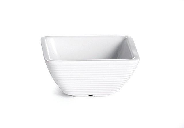A small, empty, white ceramic ramekin with a square shape and gently rounded edges. The bowl features subtle horizontal ridges on its exterior and sits on a plain white background.