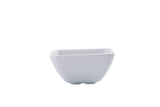 A small, white, square-shaped ceramic ramekin with slightly flared sides and subtle horizontal ridges. The bowl has a smooth finish, is dishwasher safe, and stands on a short, flat base against a plain white background.
