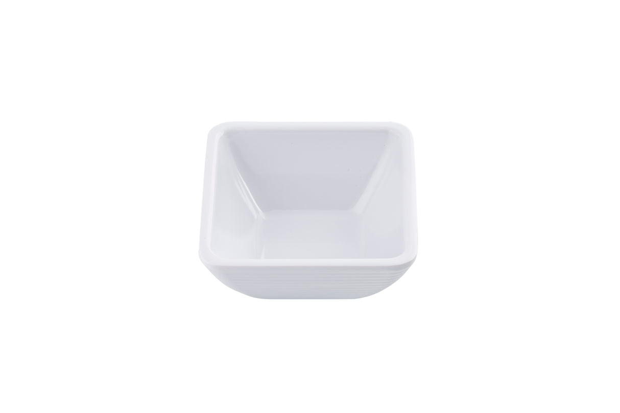 A small, empty, white, square ceramic ramekin with slightly rounded edges sits on a white background, viewed from above at a slight angle.