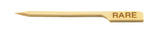 A light-colored bamboo Meat Marker Pick by TableCraft, angled to one side with a pointed tip and the word RARE burned into its flat end, commonly used to indicate a rare-cooked steak.