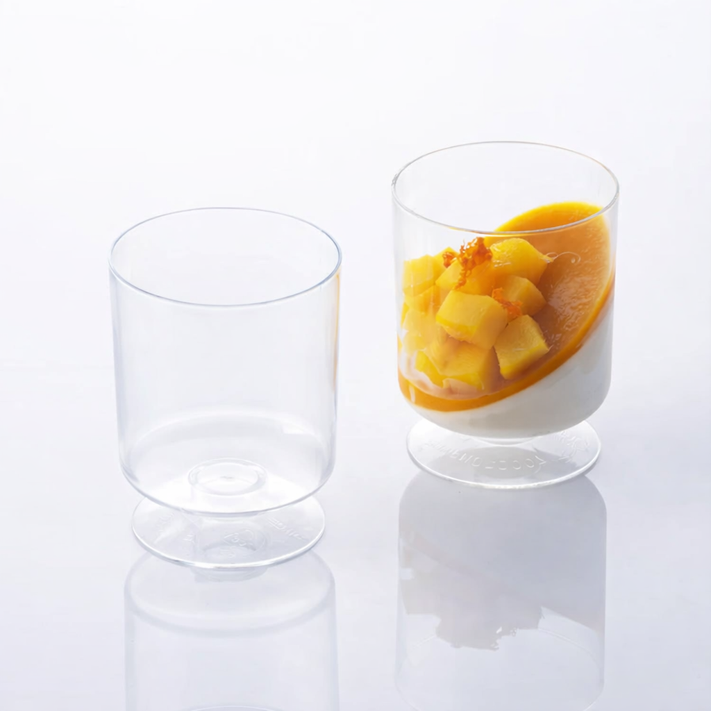 A disposable goblet glass with fruit in it adds a touch of elegance to any occasion.