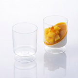 A disposable goblet glass with fruit in it adds a touch of elegance to any occasion.