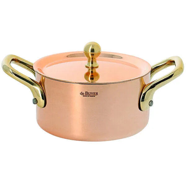 A shiny De Buyer Copper Stewpan with a mirror polishing finish features gold-colored brass handles and a lid knob. The pot has a smooth, polished surface, sturdy riveted handles, and the brand name is printed on the side.