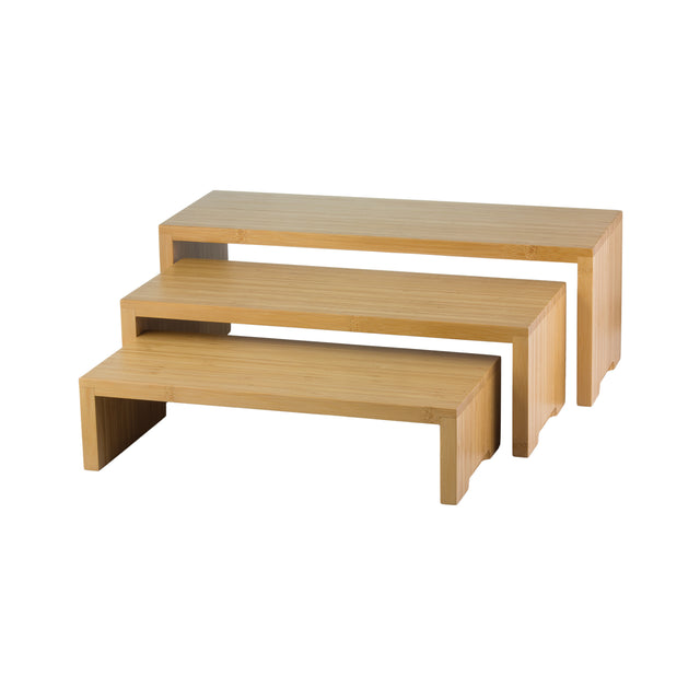 Three rectangular bamboo risers of varying heights are nested together on a white background. This TableCraft Products bamboo nesting set, known as Cascade Risers, features clean lines and a natural wood grain finish for stylish display or organization.