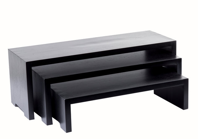 Three black rectangular Cascade Risers form a sleek nesting set, stacked together for a modern, minimalist look. Each TableCraft Products table features clean lines and a solid, blocky shape against a plain white background.
