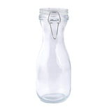 A clear glass carafe with a wide body, narrow neck, and a metal clasp securing its re-sealable glass lid. The empty bottle stands upright on a white background.