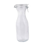 A clear, empty glass carafe with a curved neck and wide base, sealed with a hinged metal clasp and round glass lid. This 34 oz bottle stands upright against a plain white background.