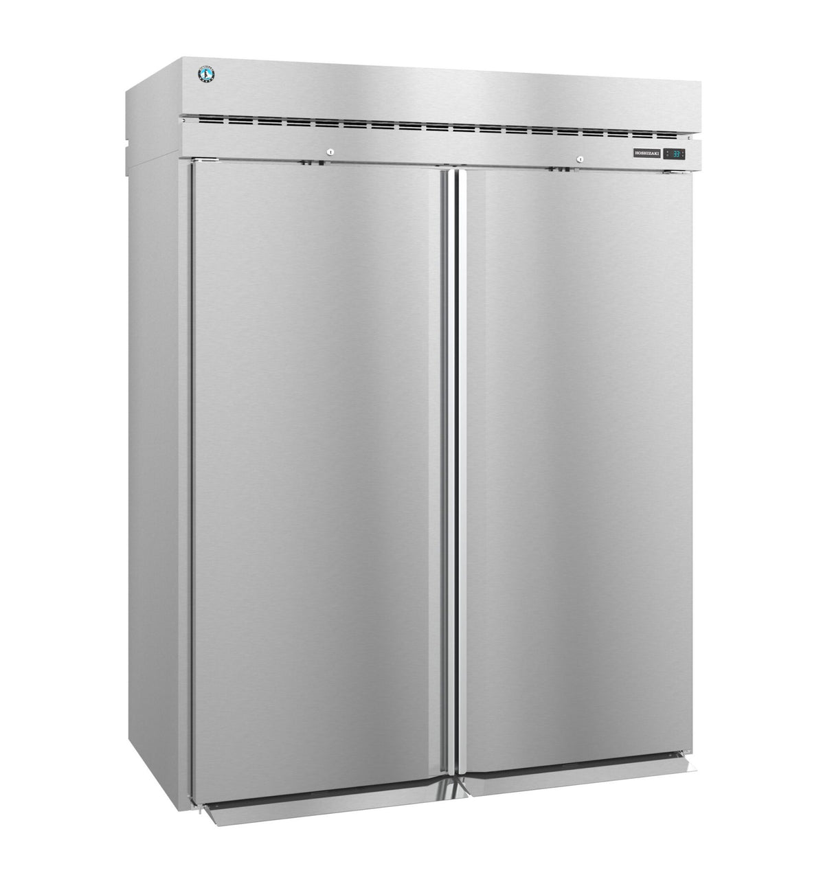 A large, industrial Steelheart Series Refrigerator stands upright with a smooth metallic finish, vertical handles, top ventilation, and a small round blue logo on the upper left. This commercial refrigerator is closed and unadorned, boasting a modern, sleek appearance.