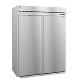 A large, industrial Steelheart Series Refrigerator stands upright with a smooth metallic finish, vertical handles, top ventilation, and a small round blue logo on the upper left. This commercial refrigerator is closed and unadorned, boasting a modern, sleek appearance.