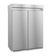 A large, industrial Steelheart Series Refrigerator stands upright with a smooth metallic finish, vertical handles, top ventilation, and a small round blue logo on the upper left. This commercial refrigerator is closed and unadorned, boasting a modern, sleek appearance.