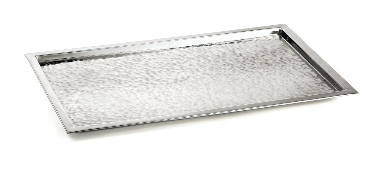 A rectangular TableCraft tray crafted from 18/8 stainless steel, featuring a slightly raised rim and a textured, hammered surface. Positioned at an angle on a white background, its clean edges highlight the modern, minimalist design.