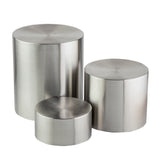 Three brushed stainless steel cylinders of varying heights and diameters are placed close together on a white background. The riser set features flat tops and smooth, reflective surfaces with visible circular machining patterns.