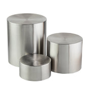 Three brushed stainless steel cylinders of varying heights and diameters are placed close together on a white background. The riser set features flat tops and smooth, reflective surfaces with visible circular machining patterns.