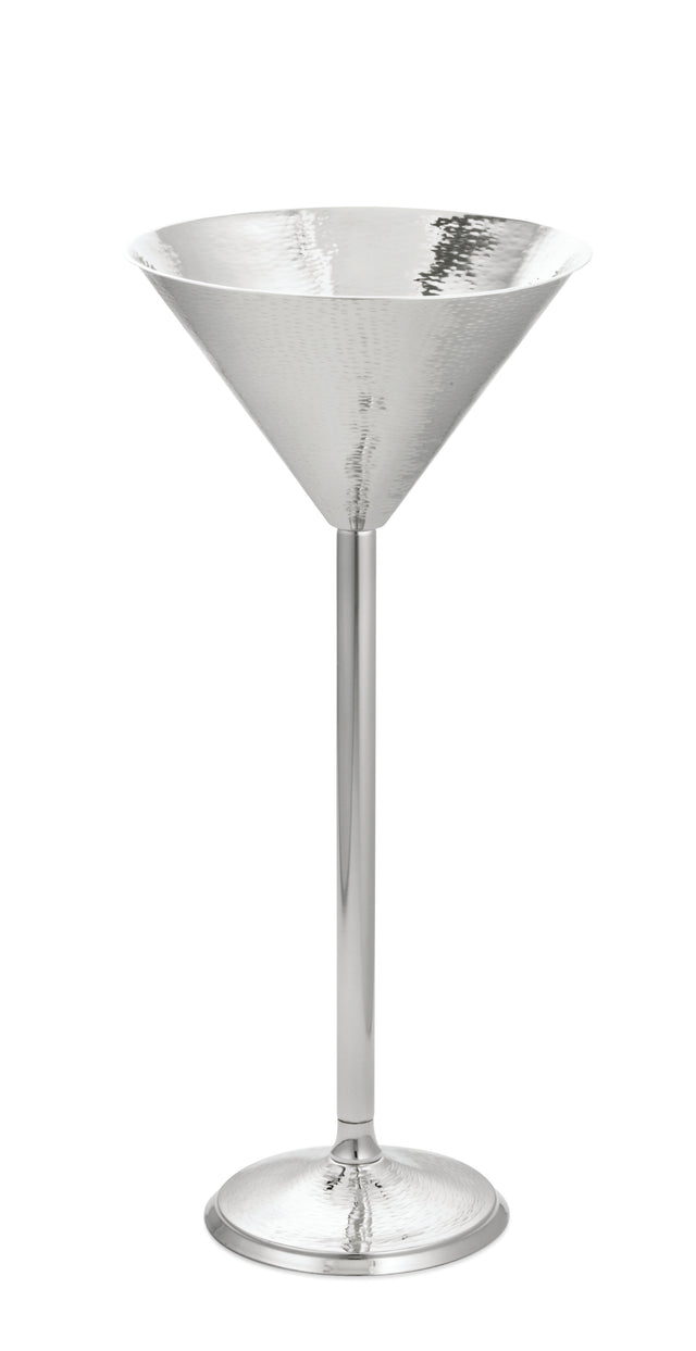 A tall, elegant martini glass from the Remington Collection, crafted in shiny hammered stainless steel with a wide conical bowl, long thin stem, and round base—all with a reflective silver finish—set against a white background.