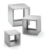 Three hollow, cube-shaped frames in brushed stainless steel form the Barclay Riser Set. With clean, smooth edges and open faces, these modern, minimalist cubes are grouped together on a white background.