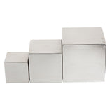 Three shiny brushed stainless steel cubes of increasing size are arranged in a row, touching each other side by side, from smallest on the left to largest on the right, against a plain white background—this is the Barclay Riser Set.