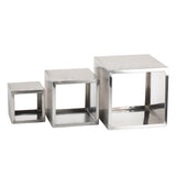 Three hollow brushed stainless steel cubes of varying sizes are arranged side by side on a white background. Each open-front cube in the Barclay Riser Set showcases smooth metallic surfaces and sharp edges, increasing in size from left to right.
