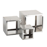 Three hollow, metallic, square cubes of varying sizes are arranged together. Each Barclay Riser Set features open sides and a shiny, brushed stainless steel finish, creating a minimalist geometric design with closely stacked, slightly overlapping cubes.