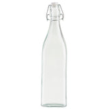 The Prima Glass Bottle is a clear, empty 34 oz bottle with a tall, slender shape and square base. Featuring a re-sealable swing-top lid with a white stopper and metal clasp, it stands upright against a plain white background.