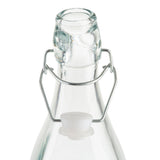 Clear Prima Glass Bottle with a re-sealable metal swing-top closure and white plastic stopper. The 34 oz bottle has a slightly tapered neck, with metal wires looped around to secure the stopper. The image background is white.