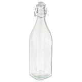 A clear, empty Prima Glass Bottle with a square base and a narrow neck, topped with a re-sealable metal swing-top closure and white cap. This 34 oz. bottle stands upright on a white background.