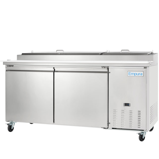 An Empura Refrigeration stainless steel pizza prep table featuring two hinged doors, two upper lids, and four caster wheels. The Empura brand name and a digital control panel are conveniently placed on the bottom right front.