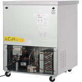 A commercial freezer with a plain metallic exterior on wheels. The lower section reveals exposed electrical components and wiring, protected by a black grille. Warning and information labels are visible on the upper metal panel of this Empura E-KUC27F.
