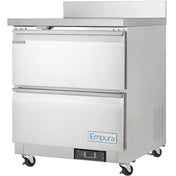 A stainless steel Empura Refrigeration work top refrigerator with two front doors, each with horizontal handles. The top section is labeled REFRIGERATOR, and the unit features four caster wheels, a digital display, and Empura branding on the lower door.