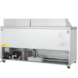 A commercial Empura refrigeration unit with its lower front panel removed exposes the cooling components, wiring, and compressor. The refrigerated sandwich prep table sits on four wheels, with warning and info labels on the right and a grille covering the exposed area.