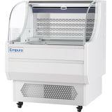 A 7.5 cu. ft. white commercial display freezer with curved glass sides and front, ventilation grilles at the bottom, and Empura Refrigeration branding. The interior Open Air Merchandiser features a metal shelf, perforated back panel, and wheels for mobility.