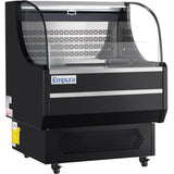 A black Empura refrigerated display case with curved glass front and ventilation grilles at the bottom. This unit sits on wheels, features clear sliding doors, and showcases Empura refrigeration for displaying chilled food items.