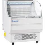 The Empura Refrigeration 7.5 cu. ft. display case features a curved glass front, white body, vented base, and caster wheels for mobility. This open air merchandiser is empty and showcases the Empura brand name on the front panel indoors.