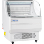 The Empura Refrigeration 7.5 cu. ft. display case features a curved glass front, white body, vented base, and caster wheels for mobility. This open air merchandiser is empty and showcases the Empura brand name on the front panel indoors.