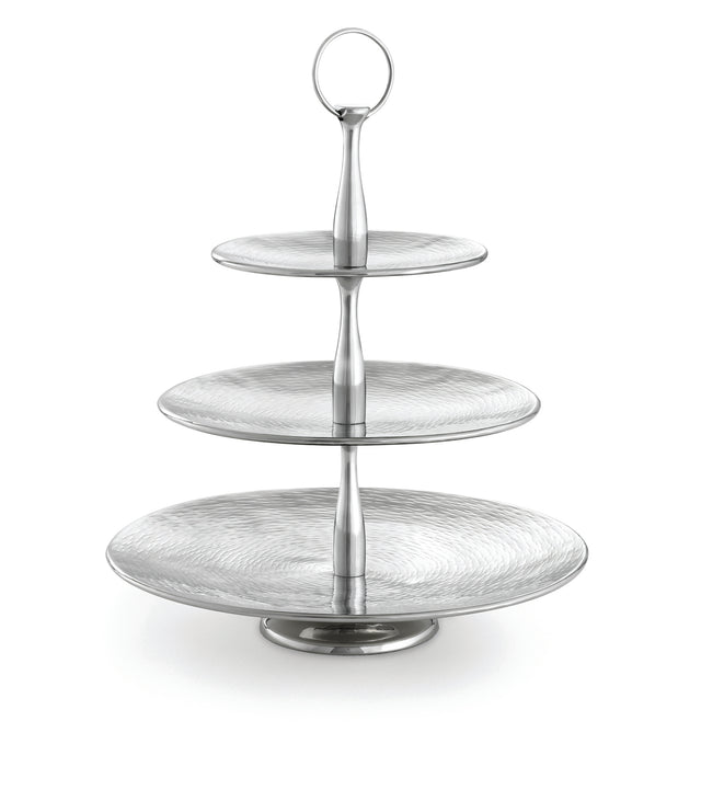 A three-tiered silver serving stand from the Remington Collection Serving Set features round, textured plates that decrease in size upward. The central column has a handle for easy carrying, and the background is plain white.
