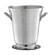 A shiny, hammered stainless steel bucket with rounded handles sits on a circular base. Part of the Remington Collection Bucket line, it features a textured, reflective finish and is dishwasher safe for easy cleaning.