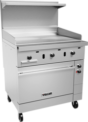 A large stainless steel commercial restaurant range by Vulcan with an electric griddle top, control knobs, oversized oven below, backsplash, upper shelf, and four wheels for mobility. The industrial design is perfect for food service use.