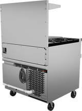 A commercial stainless steel kitchen appliance on wheels, featuring a vented cooling unit with a refrigerated base, an electrical cord, double-burner stovetop, rear shelf, and exposed piping, viewed from the back right corner against a white background.