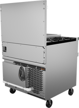 A stainless steel commercial kitchen appliance on wheels with a refrigerated base, vented refrigeration unit, power cord, and white drainage pipe. The upper section has a hinged panel and black cooktop burners. The appliance boasts a clean, modern design.