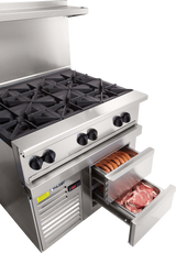 A large commercial kitchen featuring a restaurant range with gas burners and meat stored in the refrigerated base.