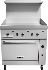 A stainless steel restaurant range features a griddle with three control knobs, a flat cooking surface, and a gas oven below. The front panel displays the Vulcan logo, while wheels provide mobility and a shelf sits above the griddle.