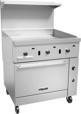 A commercial stainless steel Vulcan gas griddle with three control knobs, a flat cooking surface, a lower standard oven compartment, and a shelf above. This restaurant range is on caster wheels for mobility and features a modern, industrial design.
