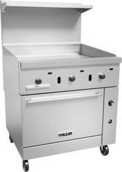 A commercial stainless steel restaurant range features a griddle with three control knobs, a flat cooking surface, a gas oven below, caster wheels for mobility, a raised backsplash, an overhead shelf, and the “Vulcan” logo on the front drawer panel.