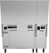 A close-up rear view of a large, industrial metal machine on wheels—likely a restaurant range—showing panels, vents, screws, handles, and openings; it appears sturdy and functional with a clean, stainless steel finish.