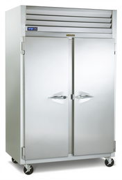 A large, stainless steel Traulsen reach-in refrigerator with two doors, sturdy handles, and a vented top section. It features a digital temperature display on the left and sits on four black caster wheels for easy mobility.