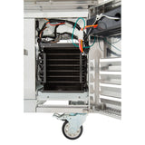 The image shows the inside of an Empura refrigeration stainless steel refrigerated stand with its door open, revealing electrical wiring and a black cooling coil unit. The cart sits on a caster wheel, with metal shelves and panels inside and to the right.