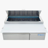 A stainless steel Empura pizza prep table with commercial refrigeration features an open top lid revealing eight black food pans. The unit includes a white cutting board and a blue Empura logo on the lower right, set against a plain white background.